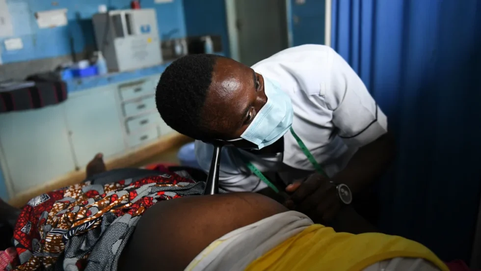 A midwife listens to an unborn baby's heartbeat at a health center in Chiradzulu, Malawi. Thoko