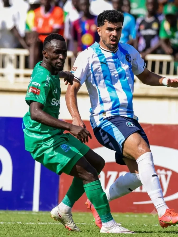 Gor Mahia's Lesley Otieno battles against Mohamed Chibi of Pyramids