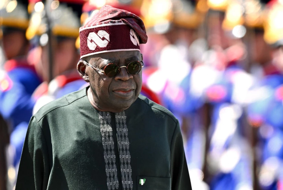 Nigeria's President Bola Tinubu reviews the honor guard during his welcome ceremony at Planalto Palace, before a meeting with Brazil's President Luiz Inacio Lula da Silva, in Brasilia, on August 25, 2025.